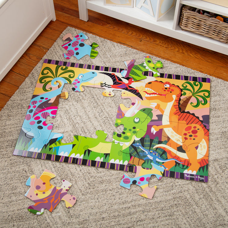 A playroom scene with The Melissa & Doug Dinosaur Dawn Jumbo Jigsaw Floor Puzzle (24 pcs, 2 x 3 feet)