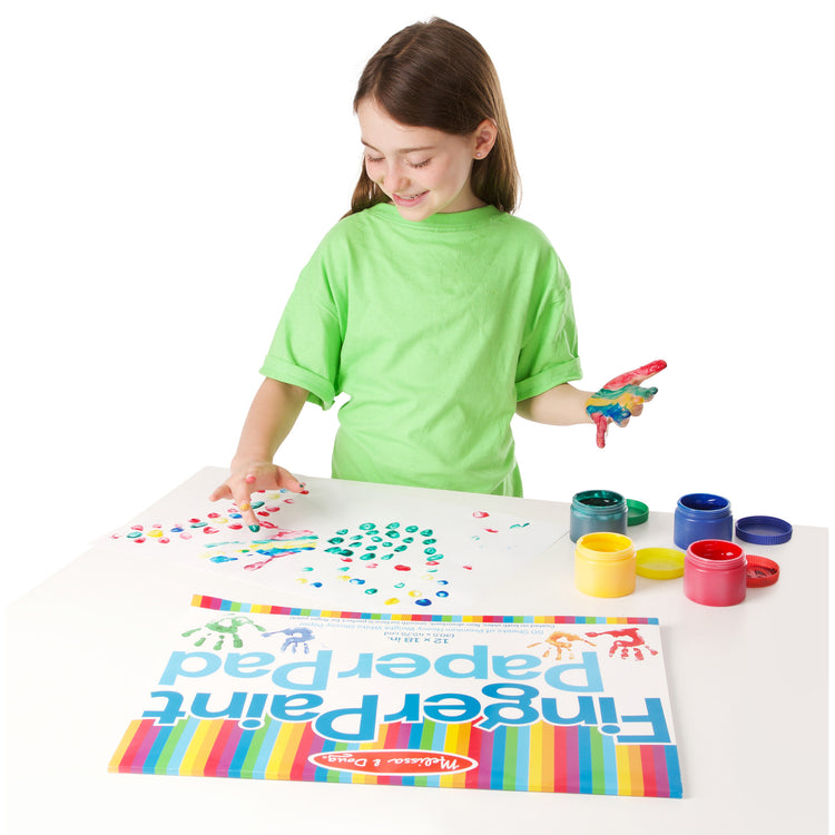 A child on white background with The Melissa & Doug Finger Paint Paper Pad - 50 12"x18" Sheets for Kids Arts And Crafts Age 2+