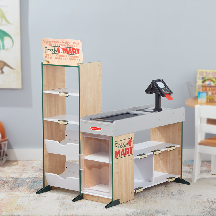 A playroom scene with The Melissa & Doug Freestanding Wooden Fresh Mart Grocery Store