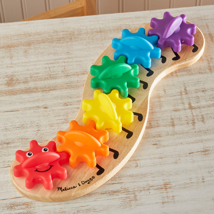 A playroom scene with The Melissa & Doug Wooden Rainbow Caterpillar Gears Toddler Toy With 6 Interchangeable Gears