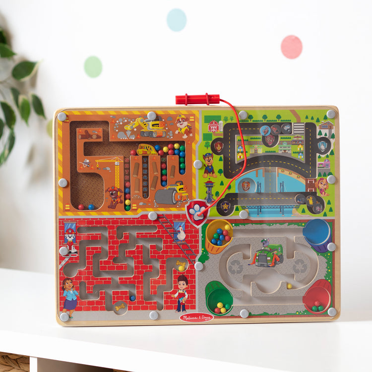 A playroom scene with The Melissa & Doug PAW Patrol Wooden 4-in-1 Magnetic Wand Maze Board