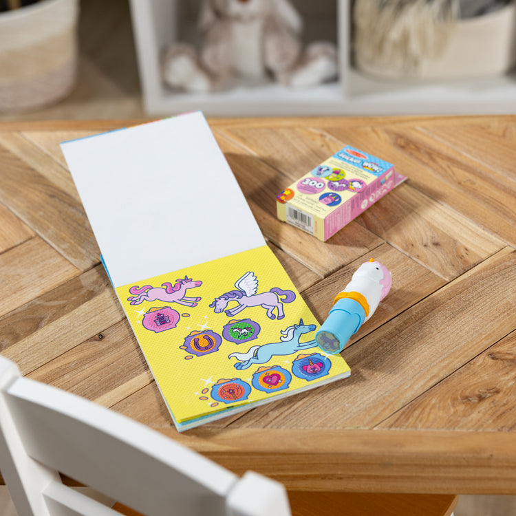 A playroom scene with The Melissa & Doug Sticker WOW!™ Unicorn Bundle: Sticker Stamper, 24-Page Activity Pad, 600 Total Stickers, Arts and Crafts Fidget Toy Collectible Character