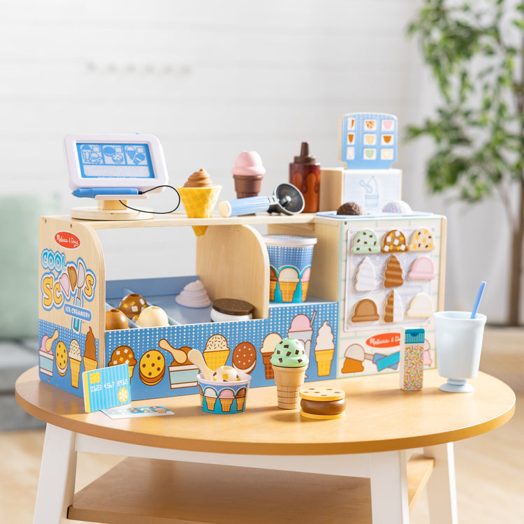 A playroom scene with The Melissa & Doug Wooden Cool Scoops Ice Creamery Play Food Toy