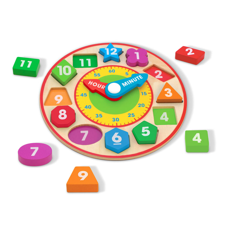 The loose pieces of The Melissa & Doug Shape Sorting Clock - Wooden Educational Toy