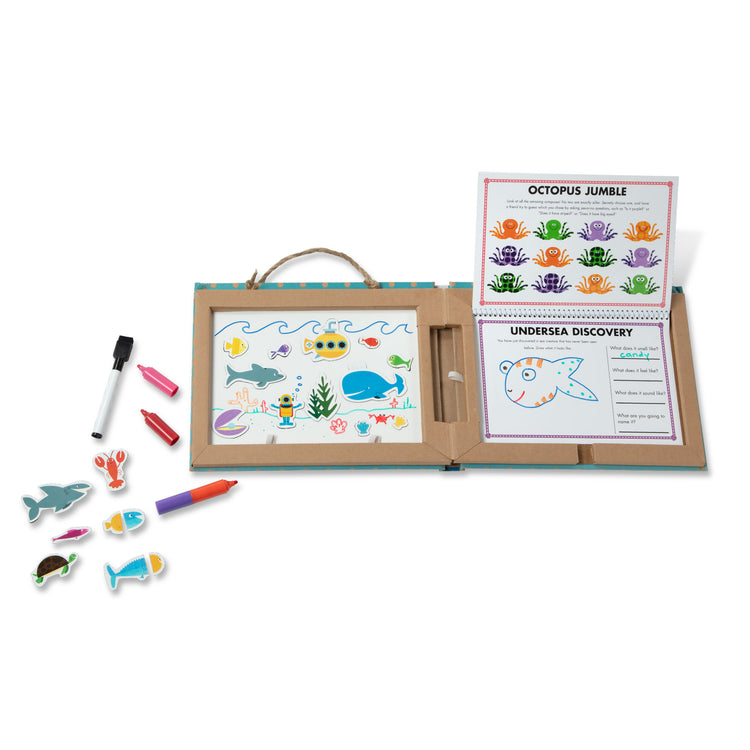 The loose pieces of The Melissa & Doug Natural Play: Play, Draw, Create Reusable Drawing & Magnet Kit – Ocean (42 Magnets, 5 Dry-Erase Markers)