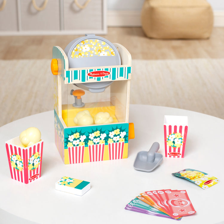A playroom scene with The Melissa & Doug Fun at the Fair! Wooden Popcorn Popping Play Food Set