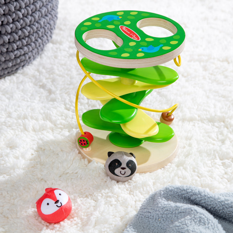 A playroom scene with The Melissa & Doug Rollables Treehouse Twirl Infant and Toddler Toy (3 Pieces)