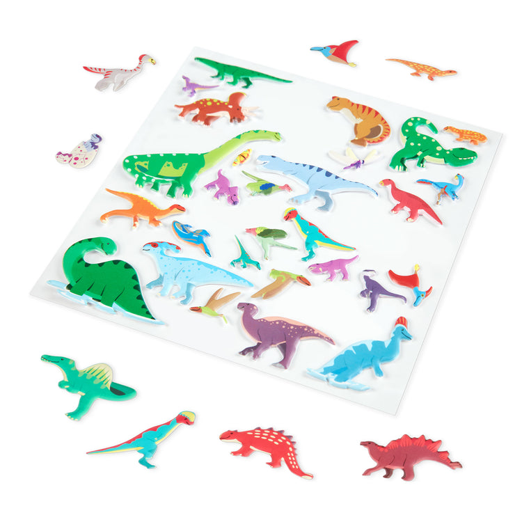 The loose pieces of The Melissa & Doug Dinosaur Puffy Sticker Play Set Travel Toy with Double-Sided Background, 36 Reusable Puffy Stickers