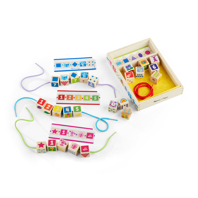 The loose pieces of The Melissa & Doug Blue’s Clues & You! Wooden Lacing Beads - 25 Beads, 4 Cords