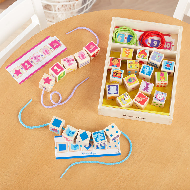 A playroom scene with The Melissa & Doug Blue’s Clues & You! Wooden Lacing Beads - 25 Beads, 4 Cords
