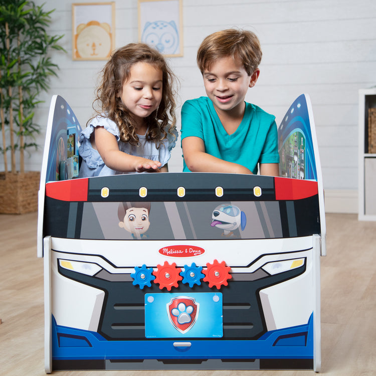 A kid playing with The Melissa & Doug PAW Patrol Wooden PAW Patroller Activity Center Multi-Sided Play Space