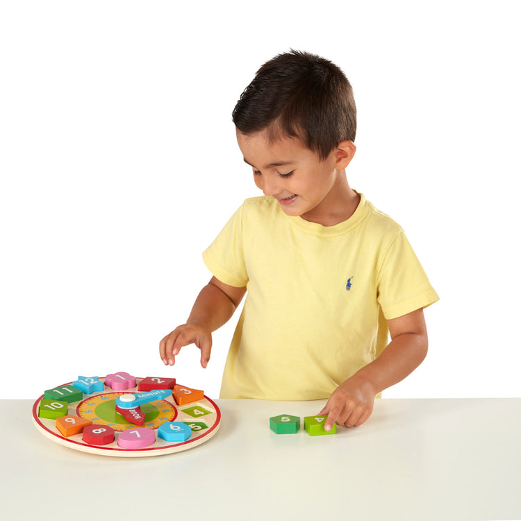 A child on white background with The Melissa & Doug Shape Sorting Clock - Wooden Educational Toy