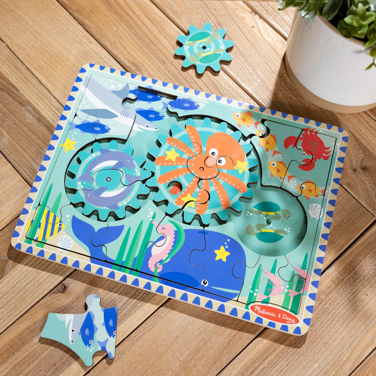 A playroom scene with The Melissa & Doug Wooden Underwater Jigsaw Spinning Gear Puzzle – 18 Pieces