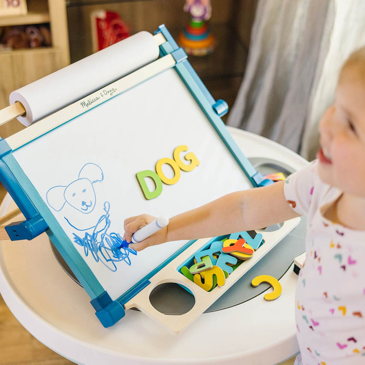 child playing with easel toy