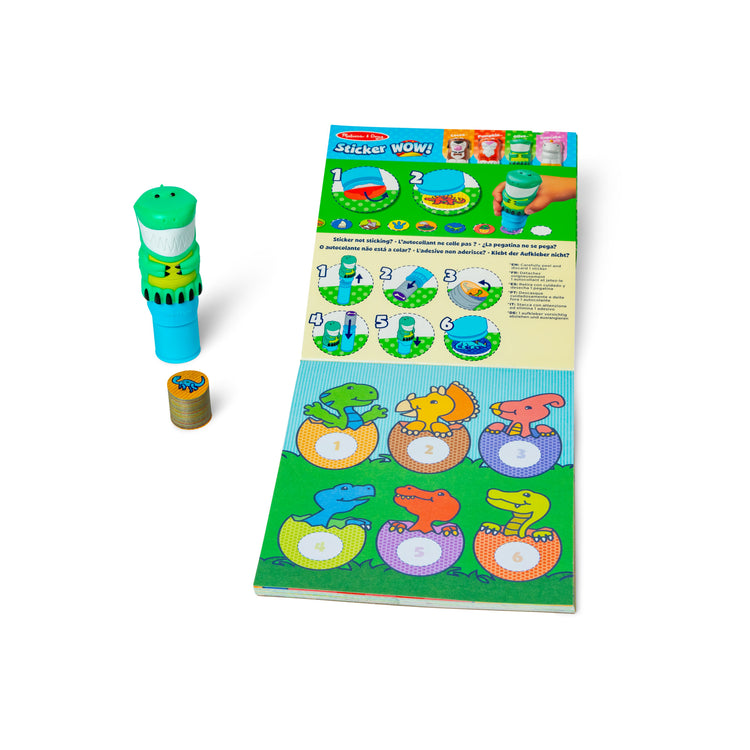 The loose pieces of The Melissa & Doug Sticker WOW!™ Dinosaur Bundle: Sticker Stamper, 24-Page Activity Pad, 600 Total Stickers, Arts and Crafts Fidget Toy Collectible Character