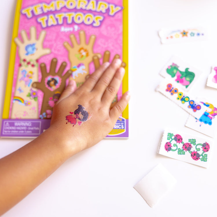 A kid playing with The My First Temporary Tattoos - Pink