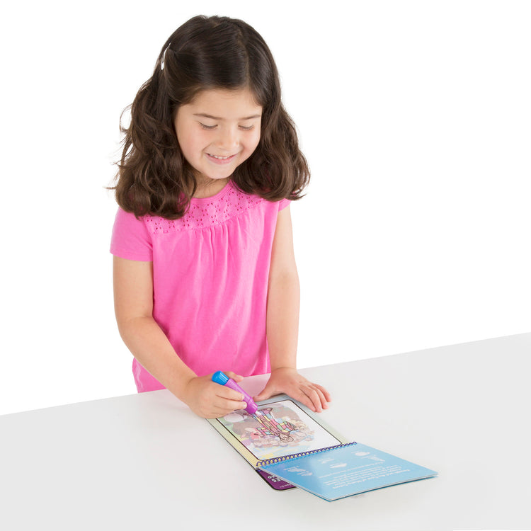 A child on white background with The Melissa & Doug On the Go Water Wow! Water Reveal Pad: Bible Stories