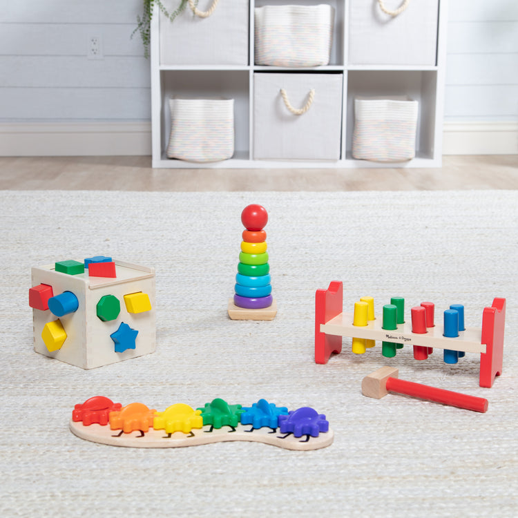 A playroom scene with The Melissa & Doug 4 Wooden Classic Rainbow Learning Toys