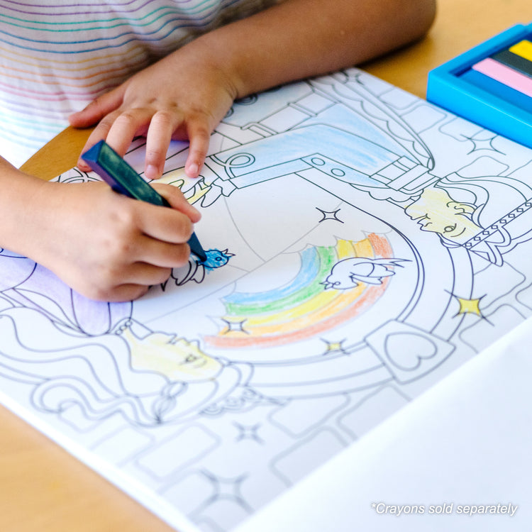 A kid playing with The Melissa & Doug Jumbo 50-Page Kids' Coloring Pad - Horses, Hearts, Flowers, and More
