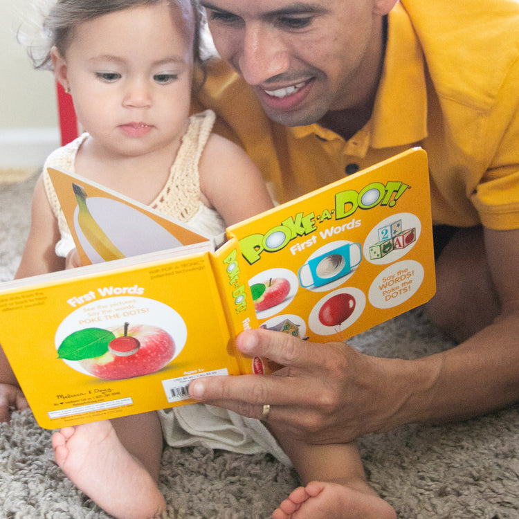 A kid playing with The Melissa & Doug Children’s Book – Poke-a-Dot: First Words (Board Book with Buttons to Pop)