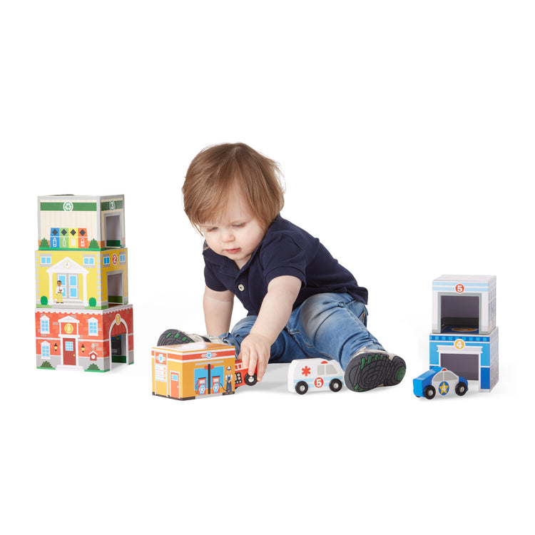 A child on white background with The Melissa & Doug Nesting and Sorting Blocks - 6 Buildings, 6 Wooden Vehicles