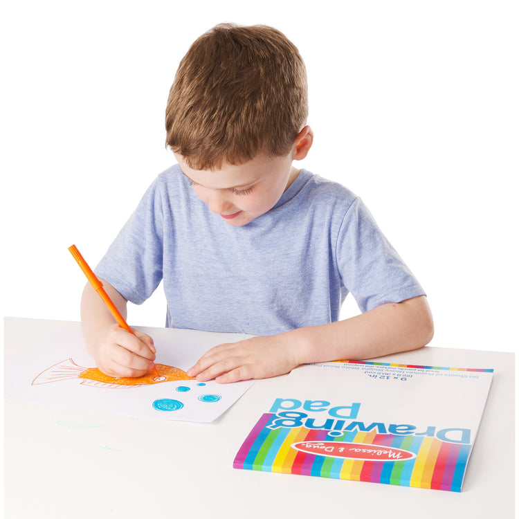 A child on white background with The Melissa & Doug Drawing Pad (9 x 12 inches) With 50 Sheets of White Bond Paper