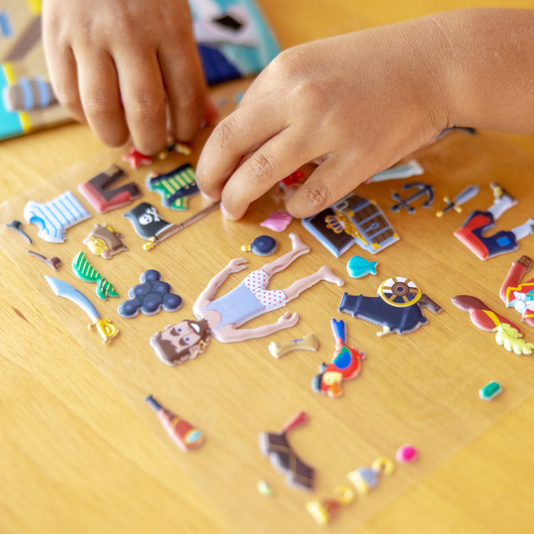 A kid playing with The Melissa & Doug Puffy Sticker Activity Book: Pirates - 51 Reusable Stickers