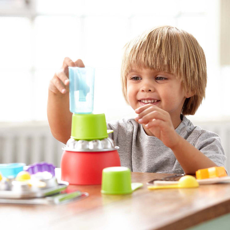 A kid playing with The Melissa & Doug Baking Play Set (20 pcs) - Play Kitchen Accessories