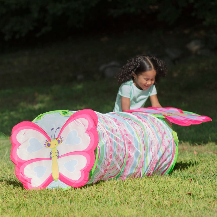 A kid playing with the Melissa & Doug Sunny Patch Cutie Pie Butterfly Crawl-Through Tunnel (almost 5 feet long)