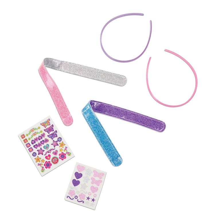 The loose pieces of the Melissa & Doug Design-Your-Own Headbands Jewelry-Making Kit With 50+ Stickers