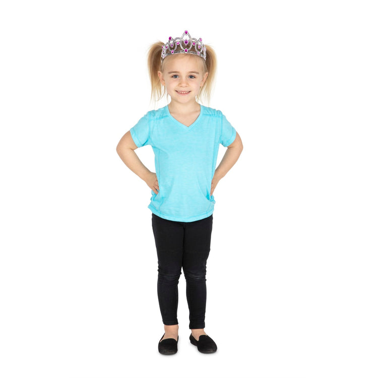 A child on white background with the Melissa & Doug Dress-Up Tiaras for Costume Role Play (4 pcs)