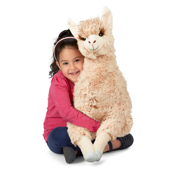 A child on white background with the Melissa & Doug Jumbo Llama Stuffed Plush Animal (26 Inches Tall)
