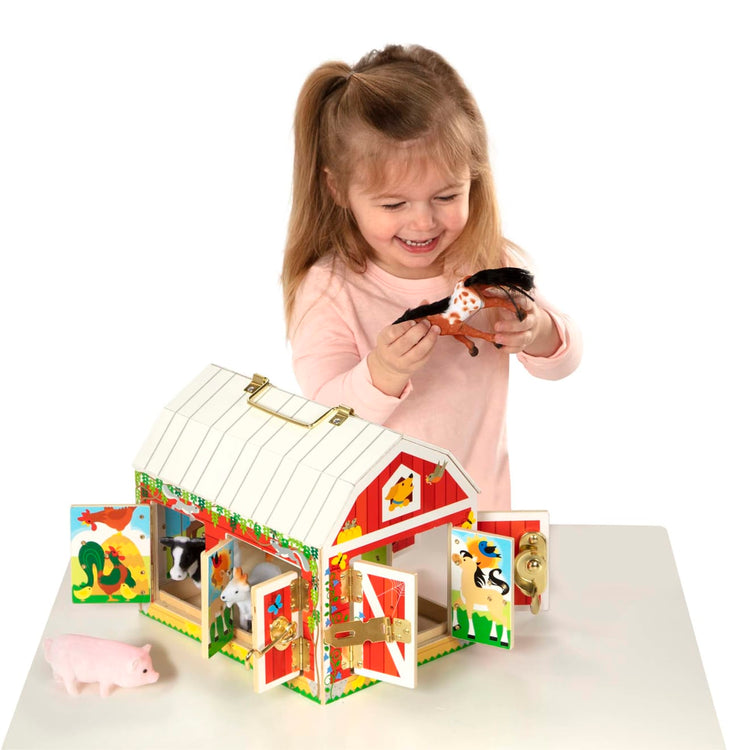 A child on white background with the Melissa & Doug Latches Wooden Activity Barn with 6 Doors, 4 Play Figure Farm Animals