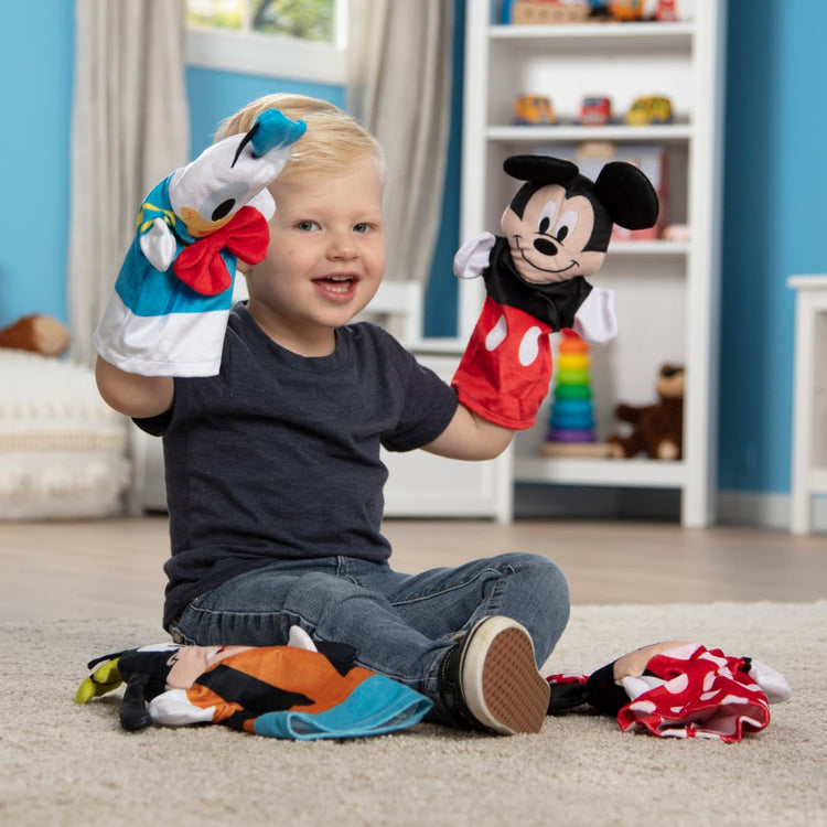 A kid playing with the Mickey Mouse & Friends Soft & Cuddly Hand Puppets
