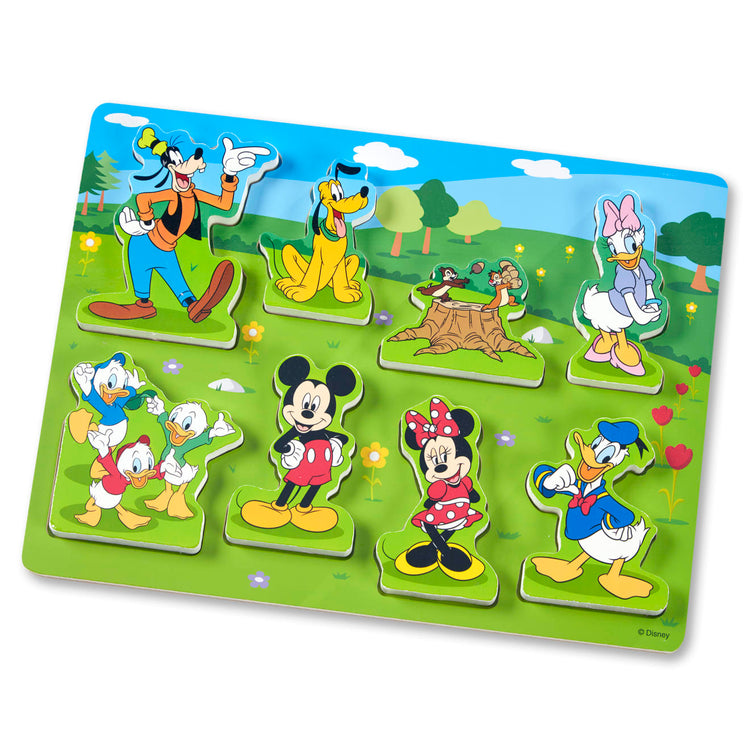 A child on white background with the Melissa & Doug Disney Mickey Mouse Clubhouse Wooden Chunky Puzzle (8 pcs)