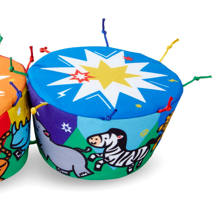 A child on white background with the Melissa & Doug K's Kids Bongo Drums Soft Musical Instrument