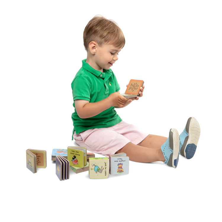 A child on white background with the Melissa & Doug Children's Book - Natural Play Book Tower: Little Nursery Books