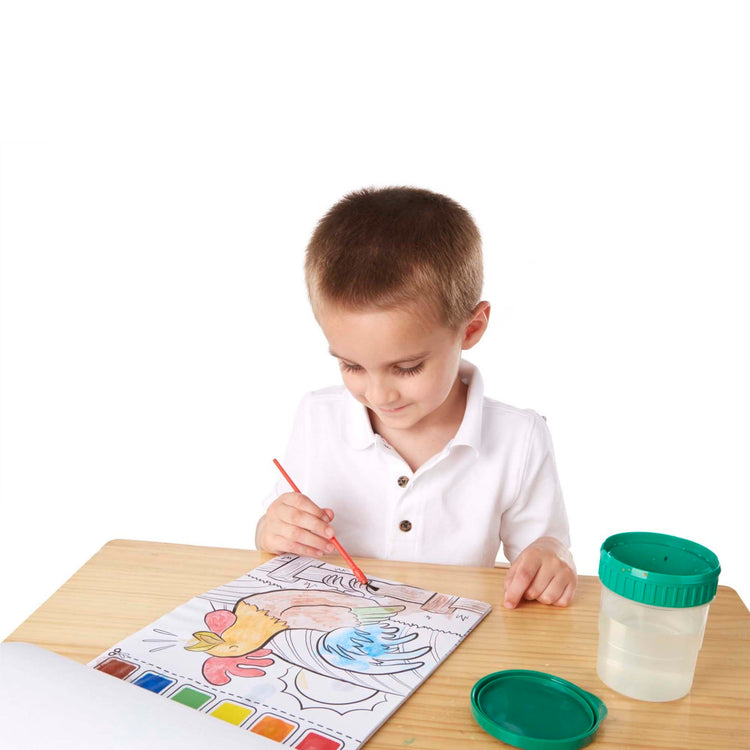 A child on white background with the Melissa & Doug Paint With Water - Farm Animals, 20 Perforated Pages, Spillproof Palettes
