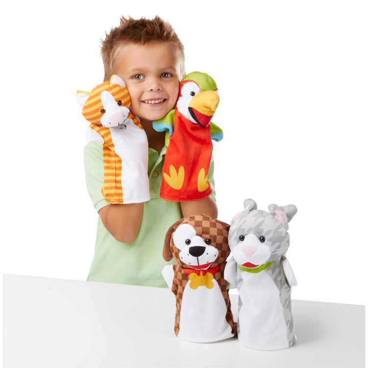 A child on white background with the Melissa & Doug Playful Pets Hand Puppets (Set of 4)