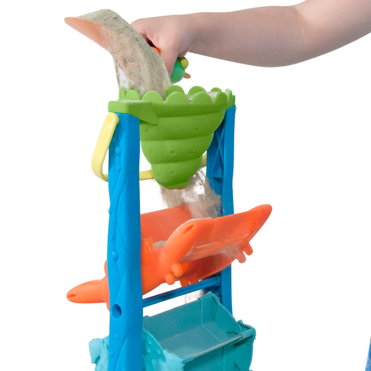 A child on white background with the Melissa & Doug Seaside Sidekicks Sand-and-Water Sifting Funnel