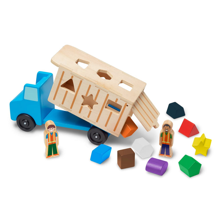 The loose pieces of the Melissa & Doug Shape-Sorting Wooden Dump Truck Toy With 9 Colorful Shapes and 2 Play Figures
