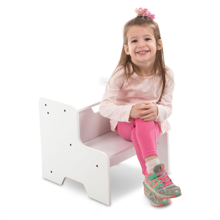 A child on white background with the Melissa & Doug Kids Wooden Step Stool - White