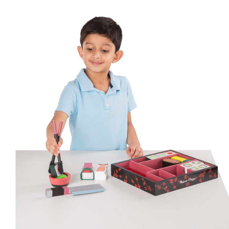 A child on white background with the Melissa & Doug Sushi Slicing Wooden Play Food Set