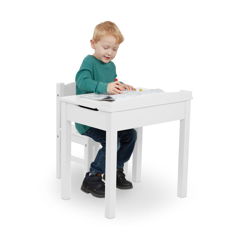 A child on white background with the Melissa & Doug Wooden Child's Lift-Top Desk & Chair - White
