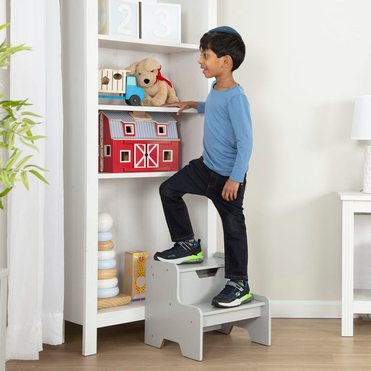 A kid playing with the Melissa & Doug Kids Furniture Wooden Step Stool - Gray