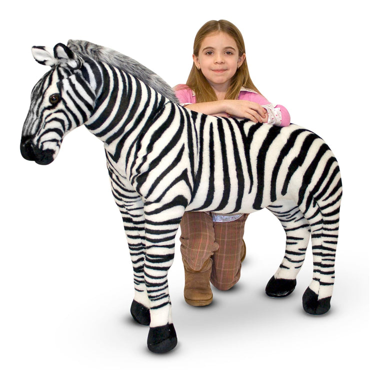 A child on white background with the Melissa & Doug Giant Striped Zebra - Lifelike Stuffed Animal (nearly 3 feet tall)