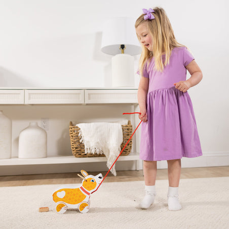 Melissa & Doug Toy Spotlight Feed, Walk & Poo Pup Play Set blog post kid playing