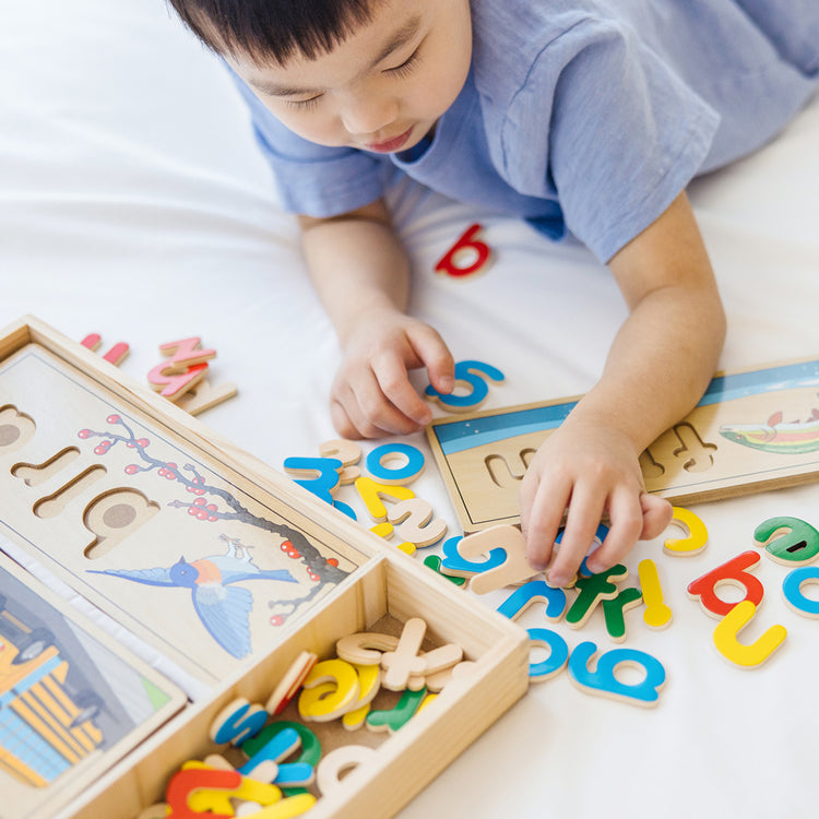 child playing with see & spell toy