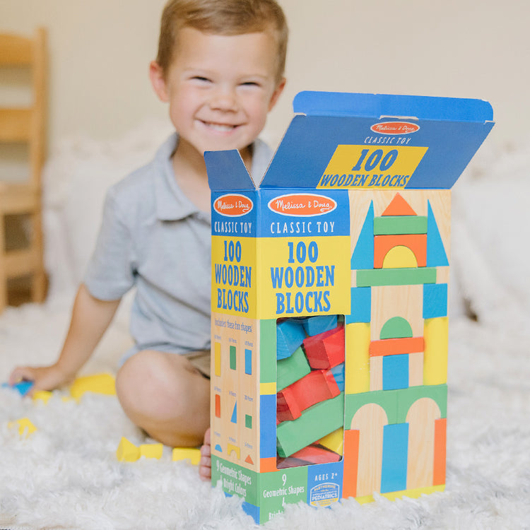 image of child with 100 wooden blocks toys