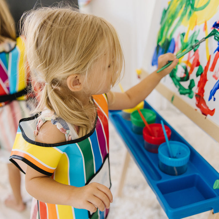 child drawing on easel toy